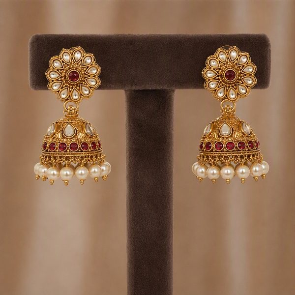 Earrings hanging from a velvet earring stand